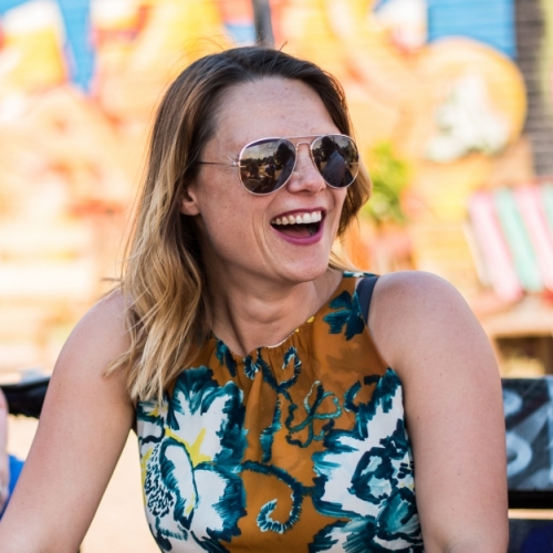 Jennie williams laughing with a blurry grafitti background