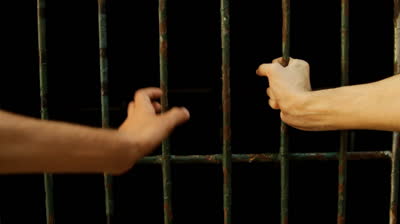 hands on jail bars