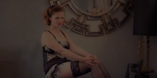Jennie sat on a stool in her chemise and stockings looking seductive.