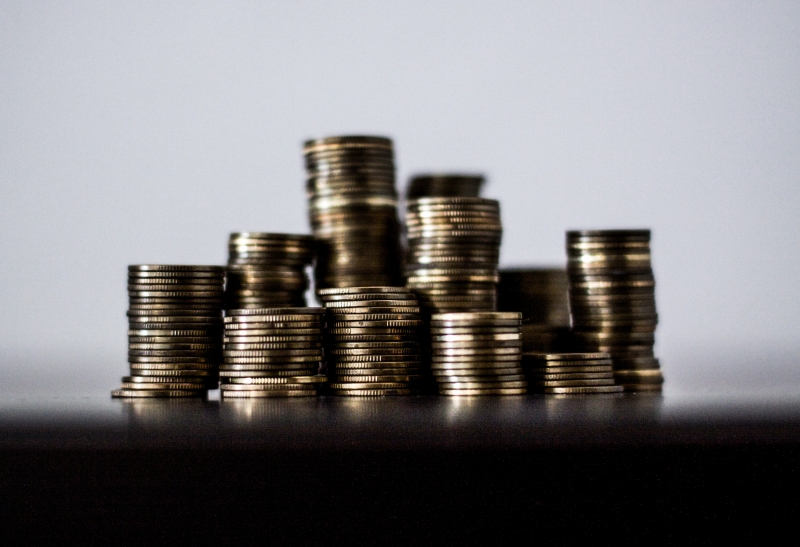 Stacks of coins on a black desk