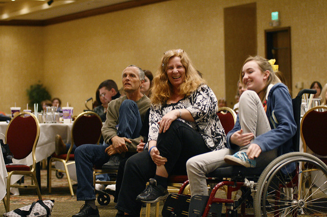 a group of people participating in wheelchair yoga