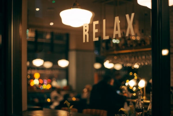 a trendy bar with the 'relax' printed on the window