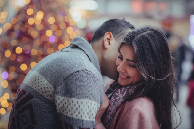 a man and woman getting close and giggling