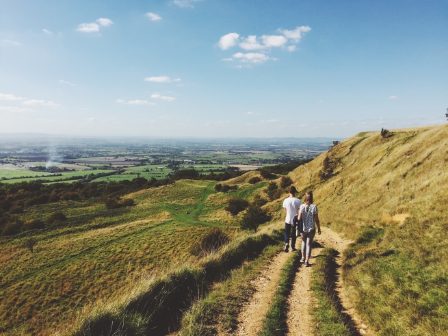 a couple walking in the open countryside