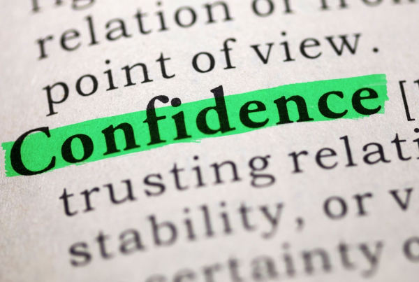 The word Confidence in a dictionary highlighted in green marker pen