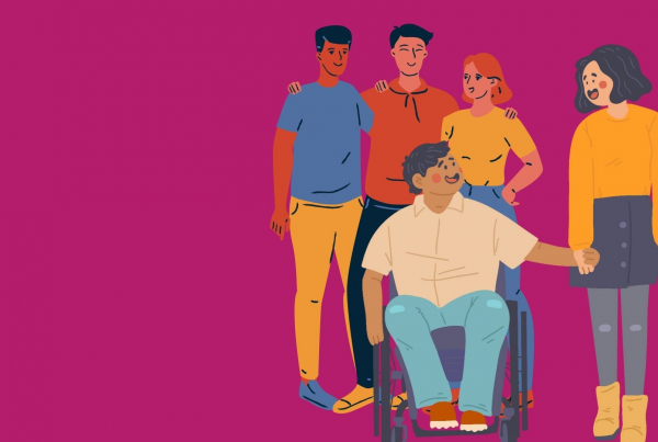 A group of young people, at the front are a young couple holding hands one of whom is a wheelchair user