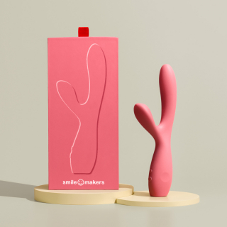 Image of the vibrator and the box. they are pink