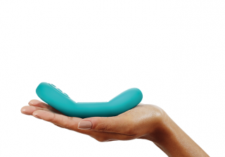 Someones hand holding the turquoise vibrator.