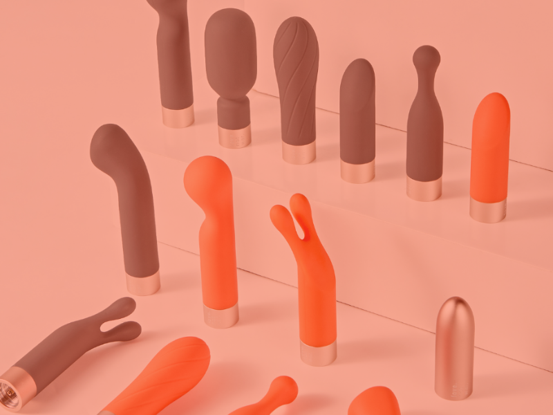 A selection of grey and orange vibrators in different shapes.