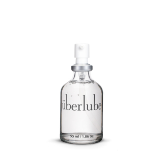 A clear glass of bottle of lubricant labelled with Uberlube