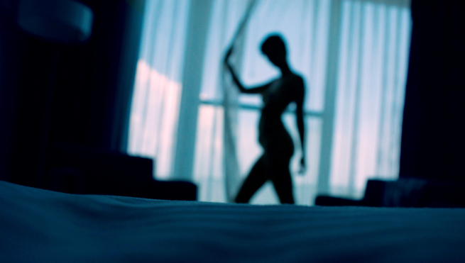 Silhouette of a woman in curtains