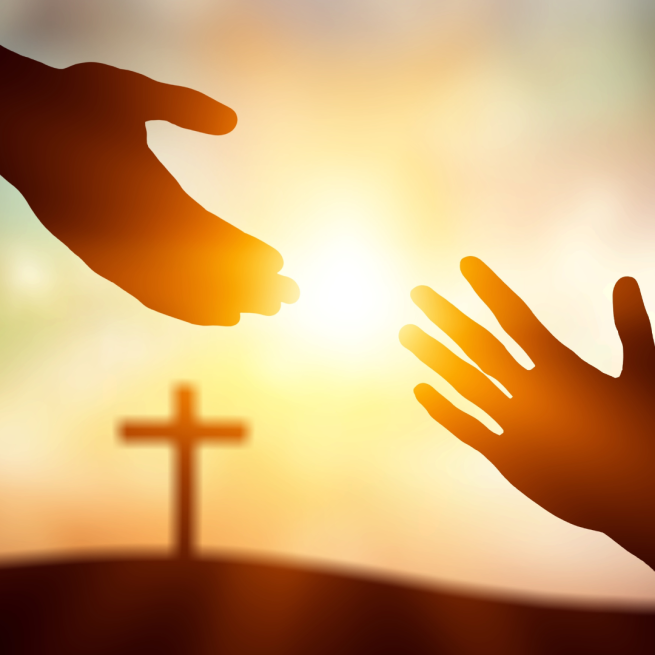 background is of a cross standing on a hill in the background with the sunsetting. In front is two hands reaching out to hold one another.