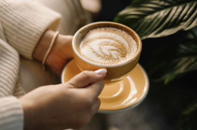 ADHD and loneliness: A person holding a cup of coffee in their hands