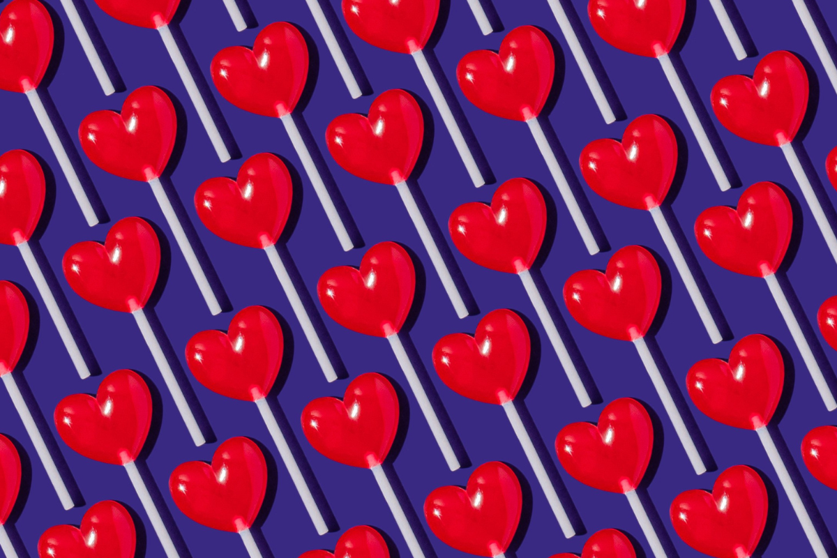 ASD and sexuality: Red lollipops in the shape of heart on a blue background.