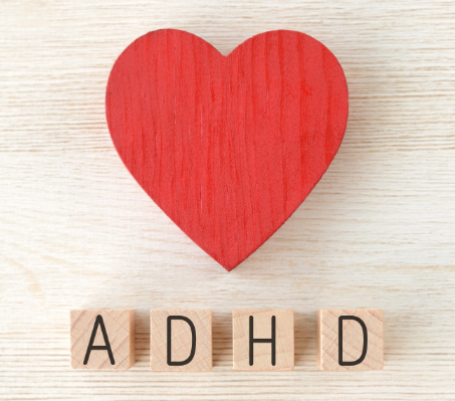 A set of wooden blocks. A heart and 4 spelling out the acronym "ADHD".