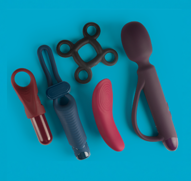 A collection of five Quest toys: from left to ring: A purple finger vibe and bullet, an adjustable blue cock ring, a cock ring with four finger loops, a small pink bullet, a large purple wand with a strap