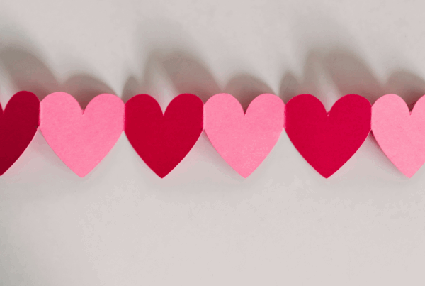 Pink and red paper heart in a chain