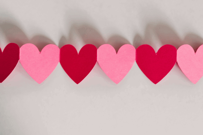 Pink and red paper heart in a chain