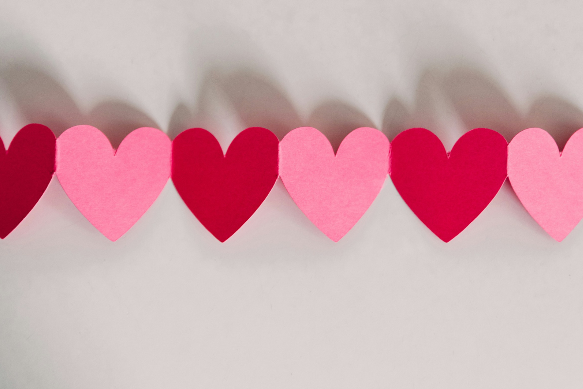 Pink and red paper heart in a chain
