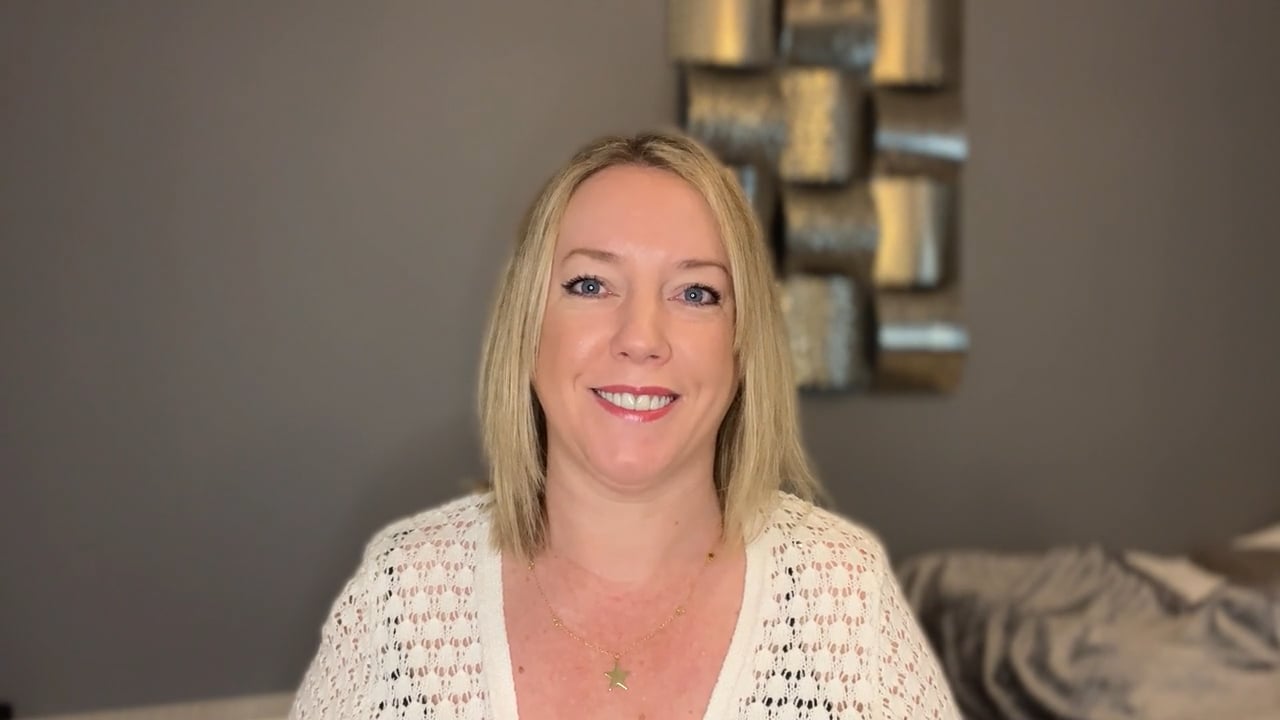 Zoe a blonde woman is smiling widely at the camera,